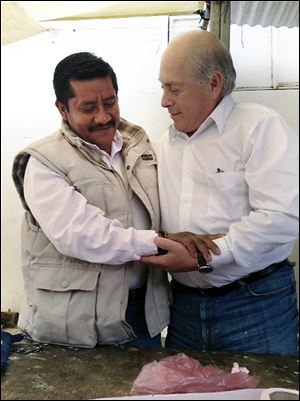 Baldemar Velasquez, right, president of the Toledo-based Farm Labor Organizing Committee, meets Mexico's Alberto Patishtan, a former Mexican college professor, in Tzotzil State Prison.
