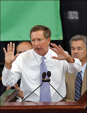 Gov. John Kasich attends a rally in the Ohio Statehouse to explain why the legislature should extend Medicaid coverage.