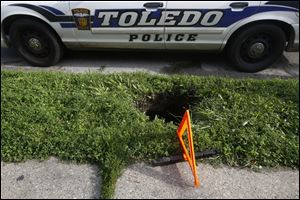 A two foot wide by five foot deep sink hole opened up on an unsuspecting East Toledo woman outside a home at 711 Nevada Street this afternoon.