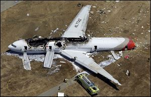 Tthe wreckage of Asiana Flight 214 lies on the ground after it crashed at the San Francisco International Airport.