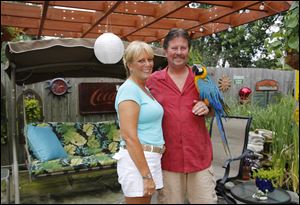 Tammy and Greg Wheeler in their Caribbean themed backyard.