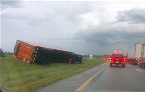 Several tractor-trailer rigs overturned on I-75 just south of Bowling Green, apparently because of high winds. 