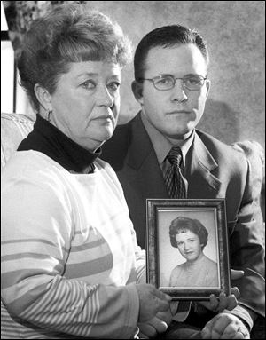 In this 2000 photo, Diane Dodd, left, and son Casey Sherman hold a photo in Rockland, Mass., of Dodd's sister Mary Sullivan, who was found strangled in January 1964 and is believed to have been the last victim of the Boston Strangler. 