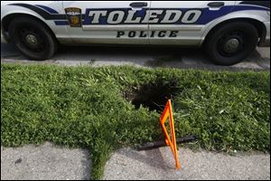 A two-foot wide by five foot deep sink hole opened up on Wednesday on an unsuspecting East Toledo woman outside a home at 711 Nevada Street.