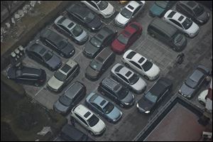 Cars are cramped into a parking lot during a day of heavy pollution in Beijing, China, in January, 2013.
