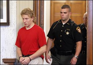 Michael Aaron Fay, 17, walks into the courtroom during his arraignment as an adult on murder charges for the killings of Blaine and Blake Romes today at the Putnam County Common Pleas Courthouse.