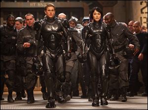 Charlie Hunnam as Raleigh Becket and Rinko Kikuchi as Mako Mori in a scene from ‘Pacific Rim.’
