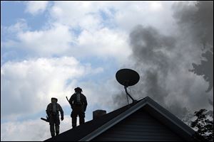 Toledo firefighters battle a blaze at 1206 and 1210 Peck, Thursday.