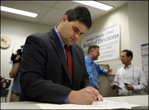 Toledo City Councilman Joe McNamara completes his paperwork today at the Lucas County Board of Elections as he files to run for mayor of Toledo.