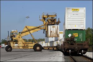 A cargo container is unloaded at Norfolk Southern’s Toledo Inter-modal Terminal. Transportation equipment exports  jumped 44 percent from 2011 to 2012, to $573 million.