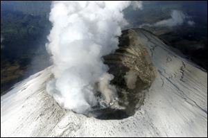 Steam and ash rise from the crater of the Popocatepetl volcano on the outskirts of Mexico City Wednesday.