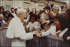 Sister Marie Andree Chorzempa, 86, center, shakes hands with Pope John Paul II in Rome in 1985. 
