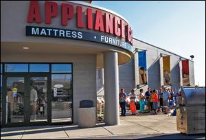 Customers wait in line for the opening of the Appliance Center's 50th anniversary sale in Maumee, Ohio.