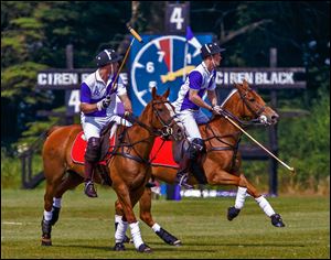 Prince William, left, and his brother, Prince Harry, play polo in a charity match about 100 miles from London. Some thought the royal birth would occur Sunday.