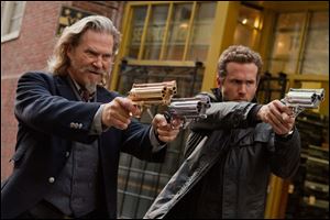 Jeff Bridges (left) and Ryan Reynolds play afterlife law enforcers in the comedy 'R.I.P.D.,' based on a comic book by Peter M. Lenkov.