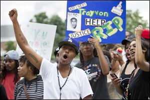People protest in front of the Guilford County Detention Center on Sunday in Greensboro, N.C., about the acquittal late Saturday of George Zimmerman in the shooting of 17-year-old Trayvon Martin.