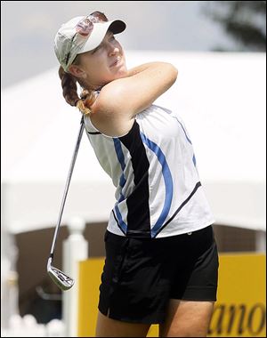 Caroline Powers, a Bowling Green High School graduate and one of the all-time best golfers to play at Michigan State, tees off during Pro-Am play Monday at Highland Meadows.