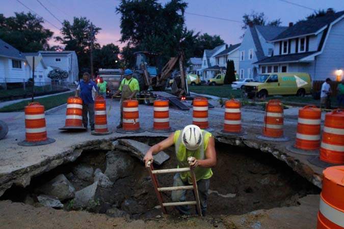CTY-waterbreak15-worker-climbs-out-of-hole