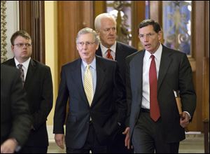 Senate Republican leaders, from right to left, Sen. John Barrasso (R., Wyo.), Sen. John Cornyn, (R. Texas), and Senate Minority Leader Mitch McConnell (R.,Ky.), walk to a closed-door meeting in the Old Senate Chamber Monday.