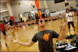 John Gunderman of Los Angeles balances clubs on his nose during the 66th annual International Jugglers’ Association Festival at Bowling Green State University.