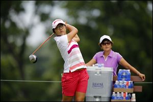 Lydia Ko tees off under the watchful eye of her mother, Tina Hyon, during a practice round Tuesday at Highland Meadows Golf Club. The 16-year-old Ko, who’s the reign­ing U.S. Ama­teur cham­pion, won the 2012 Ca­na­dian Women’s Open — an LPGA event.
