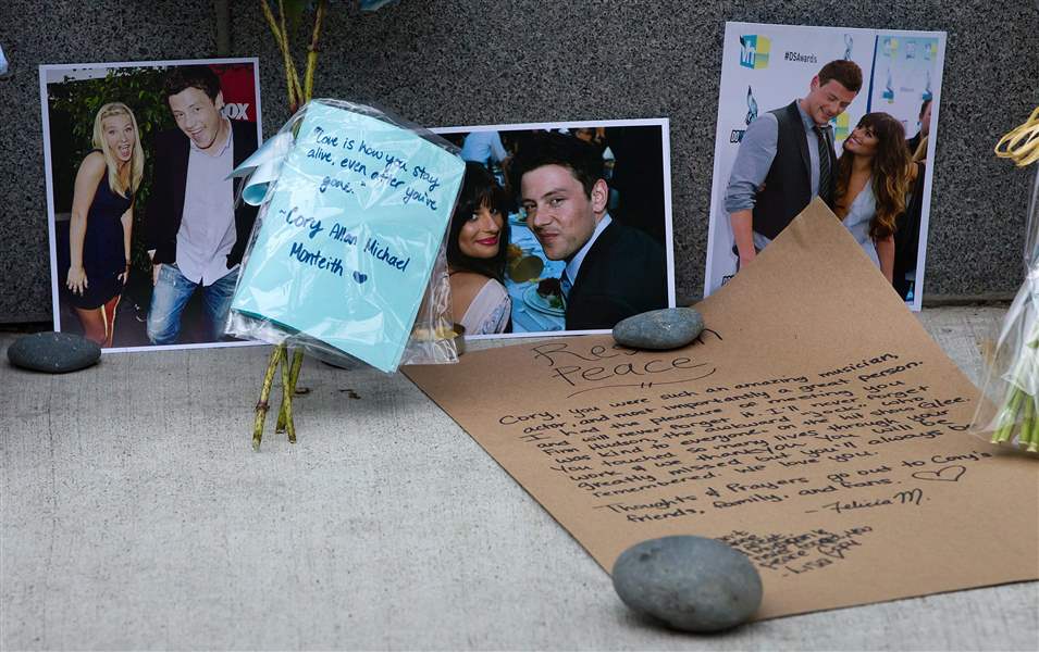 Photographs-and-notes-are-placed-at-a-memorial-f