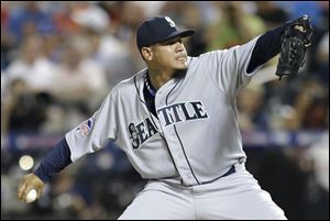 American League’s Felix Hernandez, of the Seattle Mariners, pitches during the fourth inning.