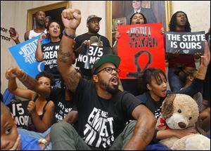 Protesters staged a sit-in outside Florida Gov. Rick Scott’s office on Tuesday  in response to the not guilty verdict in the trial of George Zimmerman, the Florida neighborhood watch volunteer who fatally shot Trayvon Martin.