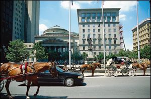 Carriages and tourists gather at Place d'Ames, which is the gateway to Old Montreal and the front yard for the Pantheon-inspired Bank of Montreal. The Canadian city, where residents speak both French and English, is rich in history.