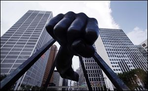 The Detroit skyline rises behind the Monument to Joe Louis, also known as 