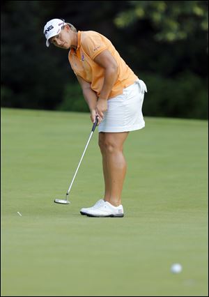 Angela Stanford sinks a birdie on No. 14 during the Fathead Celebrity Pro-Am on Wednesday at Highland Meadows Golf Club.