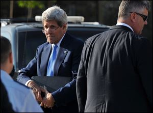 U.S. Secretary of State John Kerry arrives to board a flight to reach the West Bank city of Ramallah, where he is expected to hold new talks with Palestinian president Mahmoud Abbas on Friday, July 19, 2013 in the Jordanian capital Amman. U.S. Secretary of State John Kerry stepped up his drive Friday to get Israelis and Palestinians back to the negotiating table, facing Palestinian reluctance over his formula for resuming peace talks after nearly five years. (AP Photo/Mandel Ngan, Pool)