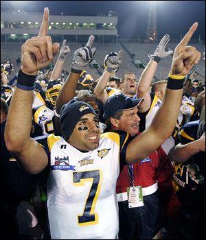 Bruce Gradkowski celebrates the Rockets’ win in the GMAC Bowl in 2005. His restaurant includes many photos of UT sports.