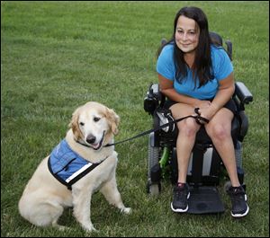 Aricca Okenka with her service dog Ingrid at her home in Toledo, Ohio. Someone tried to steal her dog on a Tarta Bus.