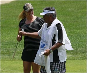 Jessica Shepley with her caddie, 'Bully' Duarte, shortly after he participated in a caddie race at the 14th hole. Duarte turned 67 on Sunday. 