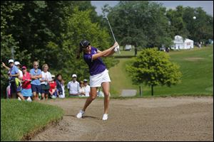 Alison Walshe hits out of the bunker on 1 during the third round of the Marathon Classic at Highland Meadows Golf Club in Sylvania, Saturday.