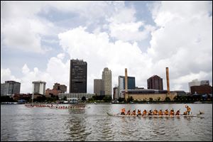 Teams face off during a race at the 12th annual Grand Maumee Dragon Boat Festival on the Maumee River. The festival on Saturday featured races of teams in 40-foot-long boats with up to 20 rowers. The Hong Kong-style boats are based on ancient Chinese designs, complete with head and tail. The festival, which had free admission, also included crafts, origami, calligraphy, and Chinese kite-flying. Proceeds from the event benefit Partners In Education. 