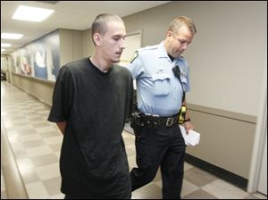 Steven King II is walked through the safety building after being arrested in connection to the missing toddler Elaina Steinfurth.