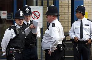 British police officers discuss outside St. Mary's Hospital exclusive Lindo Wing.