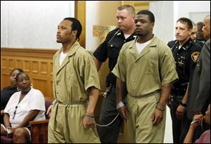 Keshawn Jennings, left, and Antwaine Jones, right, enter the Lucas County Courthouse today to be sentenced for the shooting death of a toddler, Keondra Hooks, at Moody Manor.