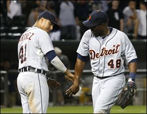 Detroit Tigers' Victor Martinez (41) celebrates with right fielder Torii Hunter the Tigers' 7-3 win over the Chicago White Sox.