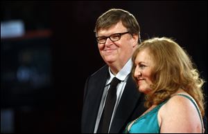 Director Michael Moore and wife Kathleen Glynn arrive for a film premiere in September, 2009.