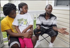 Jarice McCann, 17, Staples, Jr.'s step-brother, left, with Jakailee Staples, 8, Jr.'s step-sister, and Rudy Staples, Sr. Members of the family of Rudy Staples, Jr., speak about the 29-year-old at their home on Franklin.