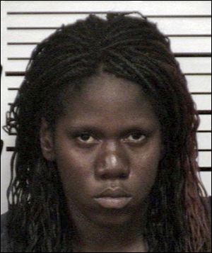 This 2012 booking photo provided by the Cuyahoga County Sheriff's Department shows Shetisha Sheeley of Cleveland. Sheeley has been identified as one of three murdered women whose remains were found in trash bags in East Cleveland, Ohio last week. (AP Photo/Cuyahoga County Sheriffs Department)