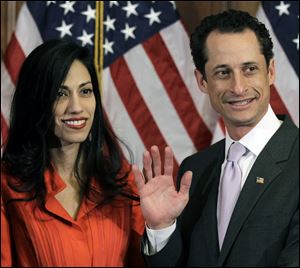 Anthony Weiner and his wife Huma Abedin pose for photographs after the ceremonial swearing in of the 112th Congress on Capitol Hill in Washington.
