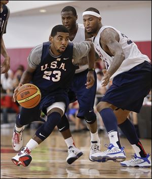 Kyrie Irving drives past Sacramento’s DeMarcus Cousins during a Team USA minicamp scrimmage this week. Irving is entering his third NBA season.