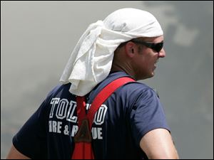 Toledo firefighters Paul Heiss keeps cool while battling a fire at the Tate Funeral home, 1003 Broadway, Toledo, Ohio, Sunday, July 11, 2010.