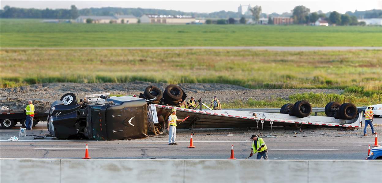 Crews-work-on-an-overturned-semi-truck-on-the-I