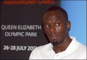 Jamaica's Usain Bolt listens during a news conference in London today. The Jamaican sprinter will compete in the 100 meters and the 4x100 relay at the two-day meeting on July 26-27, which marks the anniversary of the opening ceremony of the London Olympics.