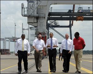 President Barack Obama, center, gets a tour of the Jacksonville, Fla. port today with, from left, Transportation Secretary Anthony Foxx; Dennis Kelly, TracPac Regional Vice President and General Manager; Ray Schleicher, CEO of the Jacksonville Port Authority, and Fred Wakefield, International Longshoreman's Association Representative,